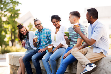 Image showing friends drinking coffee and juice talking in city