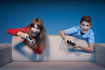 Image showing Computer game competition. Gaming concept. Excited girl playing video game with joystick