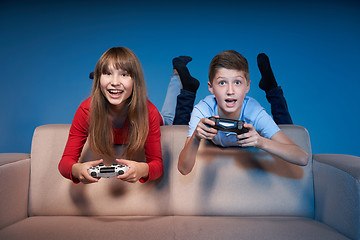 Image showing Computer game competition. Gaming concept. Excited girl playing video game with joystick