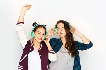 Image showing teenage girls in earphones listening to music