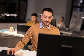 Image showing man with computer working late at night office