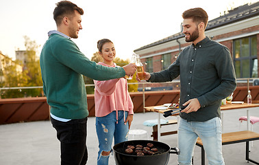 Image showing friends toast drinks at barbecue party on rooftop