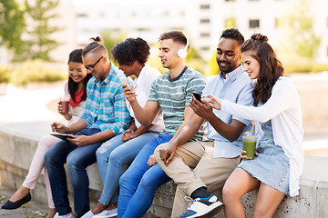 Image showing friends with smartphones hanging out in summer