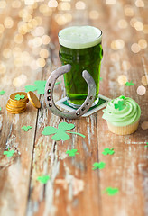 Image showing glass of beer, cupcake, horseshoe and gold coins