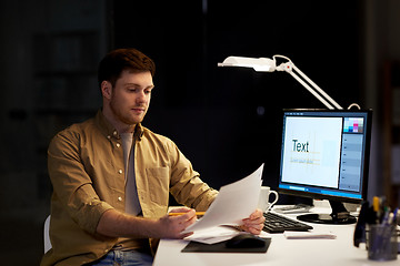 Image showing designer with papers working at night office