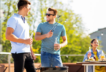 Image showing happy friends having bbq party on rooftop