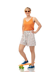 Image showing smiling teenage girl with skateboard over white