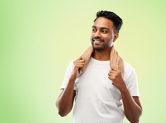 Image showing smiling indian man with towel over green 