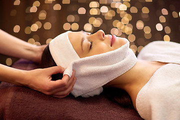 Image showing woman having face massage with towel at spa