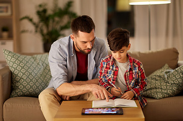 Image showing father and son doing homework together