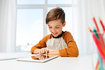 Image showing student boy with tablet pc and notebook at home