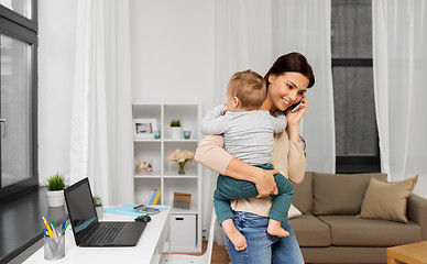 Image showing mother with baby calling on smartphone at home