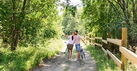 Image showing couple with bicycles taking selfie by smartphone