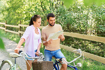 Image showing couple with map and bicycles at country in summer