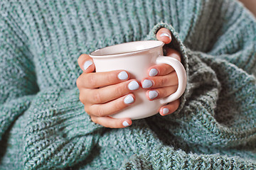 Image showing Female hands holding hot cup of coffee or tea.