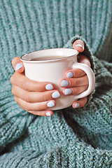 Image showing Female hands holding hot cup of coffee or tea.