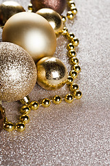 Image showing Christmas golden and brown decorations closeup on glitter backgr