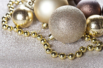 Image showing Christmas golden and brown decorations closeup on glitter backgr