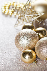 Image showing Christmas golden and brown decorations closeup on glitter backgr