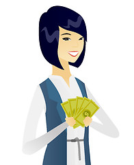 Image showing Young asian business woman holding money.