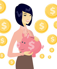 Image showing Young asian business woman holding a piggy bank.