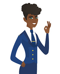 Image showing Young african-american stewardess showing ok sign.
