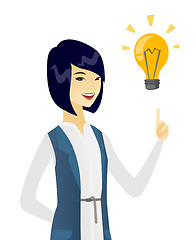 Image showing Business woman pointing at business idea bulb.