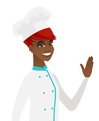 Image showing Young african-american chef waving her hand.