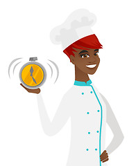 Image showing Young african-american chef holding alarm clock.