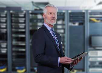 Image showing Senior businessman in network server room