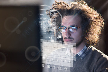 Image showing man working on computer in dark office