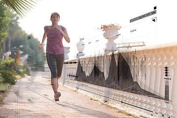 Image showing Fitness woman training and jogging in summer park