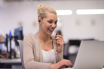 Image showing businesswoman using a laptop in startup office