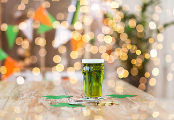 Image showing glass of green beer, horseshoe and golden coins