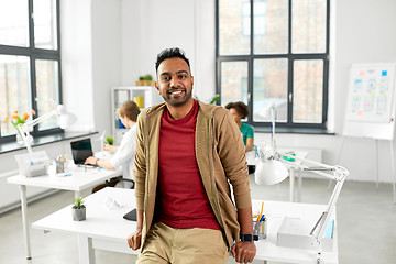 Image showing smiling indian man with smart watch at office
