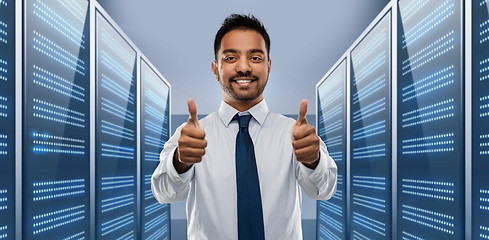 Image showing businessman showing thumbs up in server room