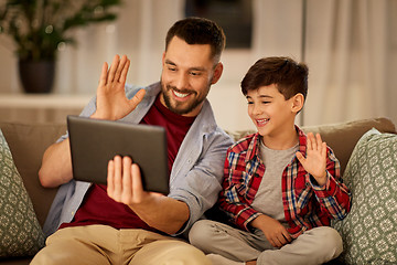 Image showing father and son with tablet pc having video chat