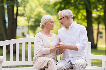 Image showing happy senior couple sitting on bench at park