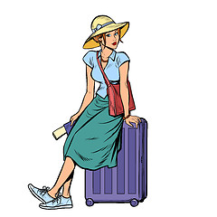 Image showing woman tourist sitting on a travel suitcase