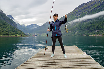 Image showing Woman fishing on Fishing rod spinning in Norway.