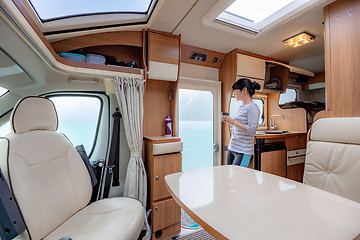 Image showing Woman in the interior of a camper RV motorhome with a cup of cof