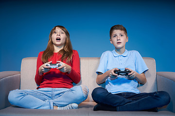 Image showing Computer game competition. Gaming concept. Excited girl playing 