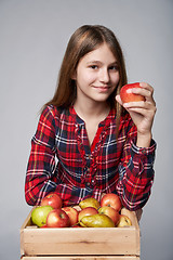 Image showing Teen girl with apples and pears in a box