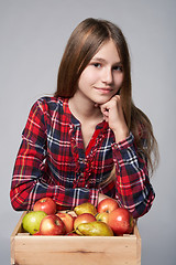 Image showing Teen girl with apples and pears in a box