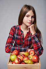 Image showing Teen girl with apples and pears in a box