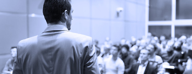 Image showing Speaker Giving Presentation at Business Conference at Lecture Hall.