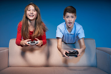 Image showing Computer game competition. Gaming concept. Excited girl playing video game with joystick