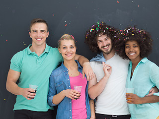 Image showing confetti party multiethnic group of people isolated over gray