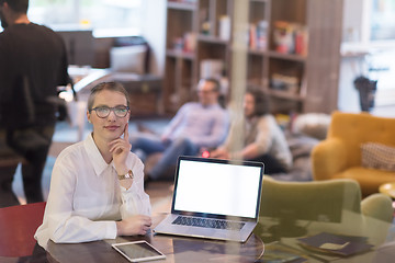 Image showing businesswoman using a laptop in startup office