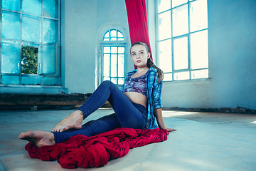 Image showing Graceful gymnast resting after performing aerial exercise at loft